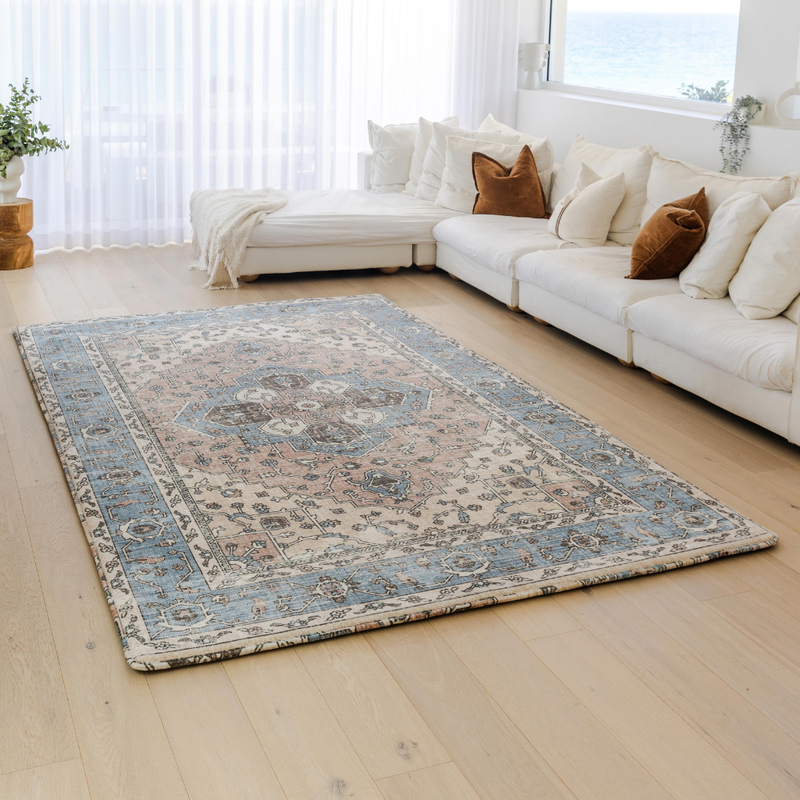 Living room with a patterned rug and white sofa