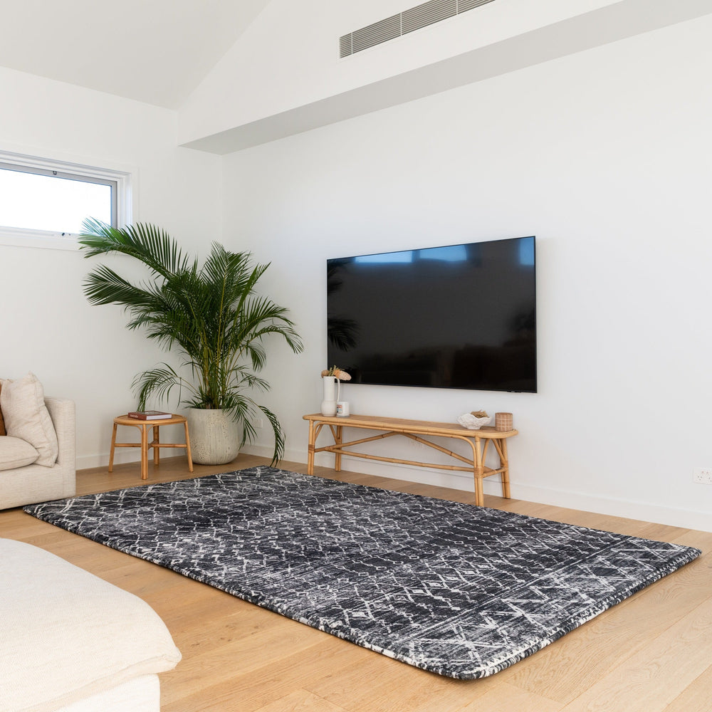 Modern living room with a beige sofa, coffee table, and TV.