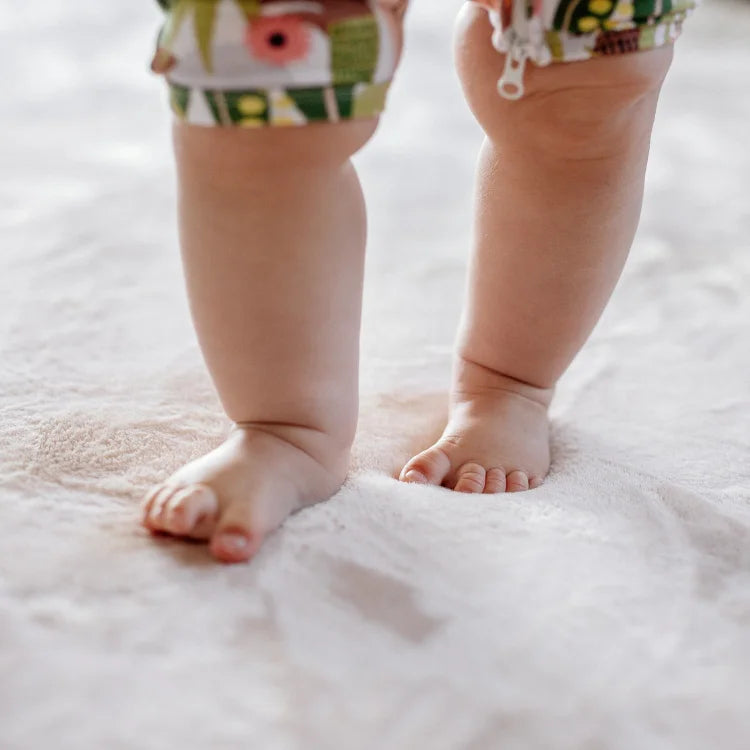 babies feet on a white carpet